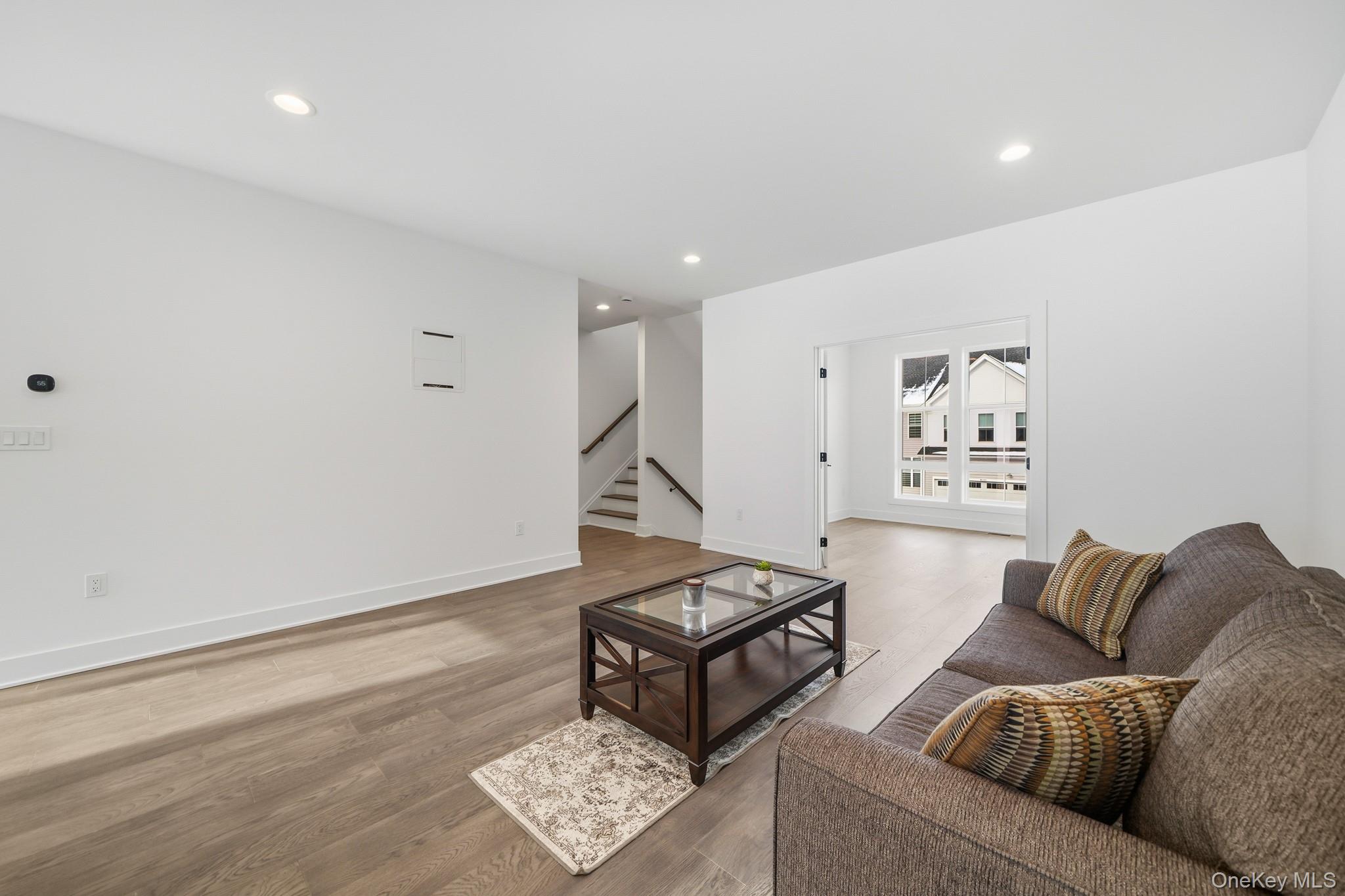 4034 Chestnut Rdg Road, Unit 62 Fishkill, NY 12524 - Photo 19 of 31 Living area featuring wood finished floors, recessed lighting, and stairway