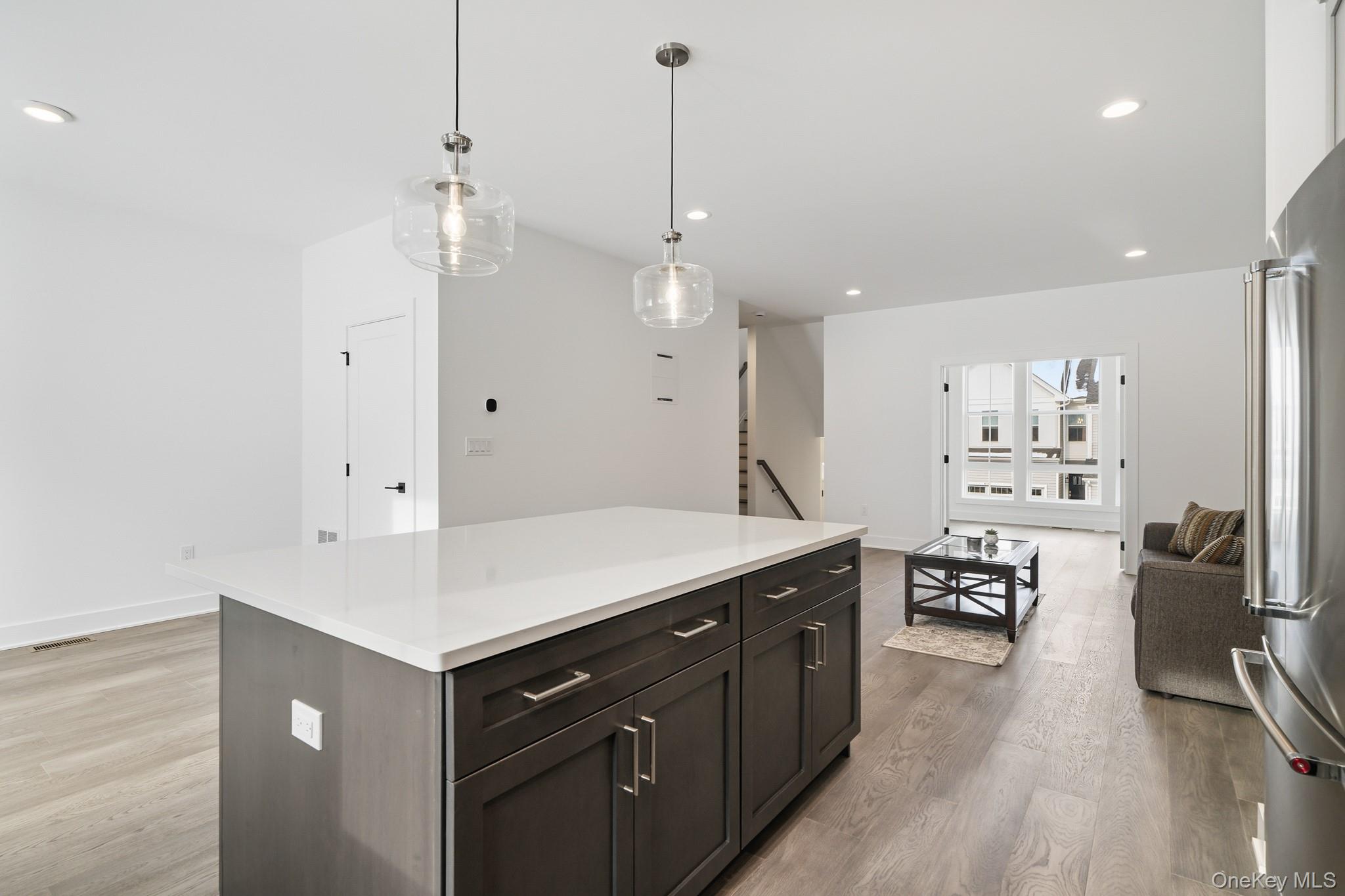 4034 Chestnut Rdg Road, Unit 62 Fishkill, NY 12524 - Photo 31 of 31 Kitchen featuring recessed lighting, a center island, hanging light fixtures, freestanding refrigerator, and open floor plan