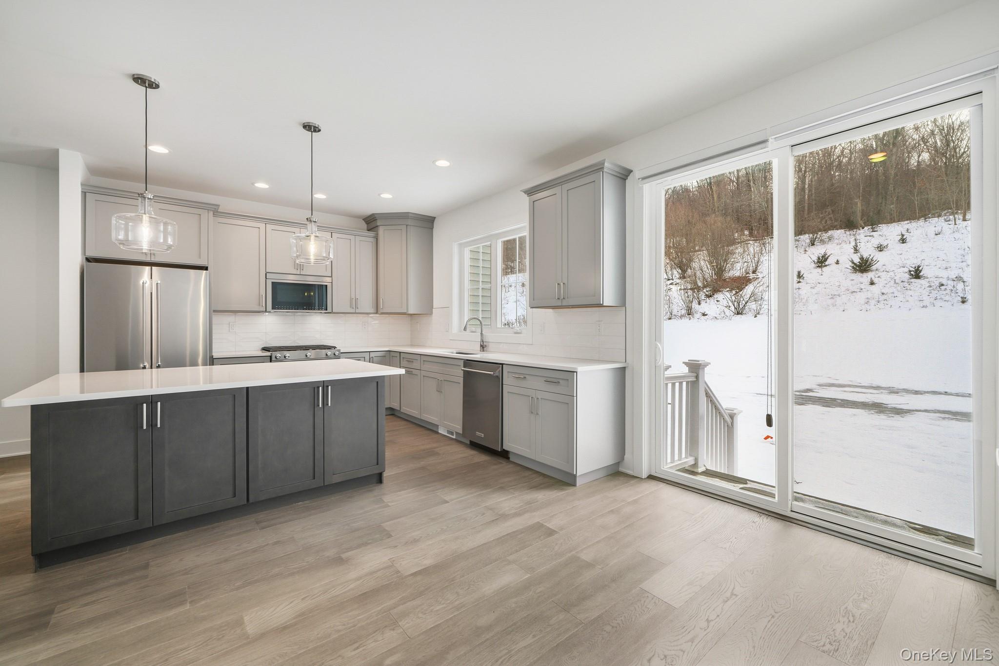 4034 Chestnut Rdg Road, Unit 62 Fishkill, NY 12524 - Photo 9 of 31 Kitchen with gray cabinets, stainless steel appliances, pendant lighting, light wood-style flooring, and recessed lighting