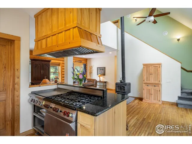 a kitchen with stainless steel appliances granite countertop a stove and a wooden cabinets