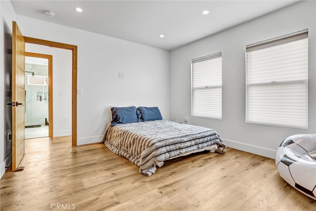 6900 Corbin Avenue Reseda, CA 91335 - Photo 14 of 50 a bedroom with a bed and wooden floor