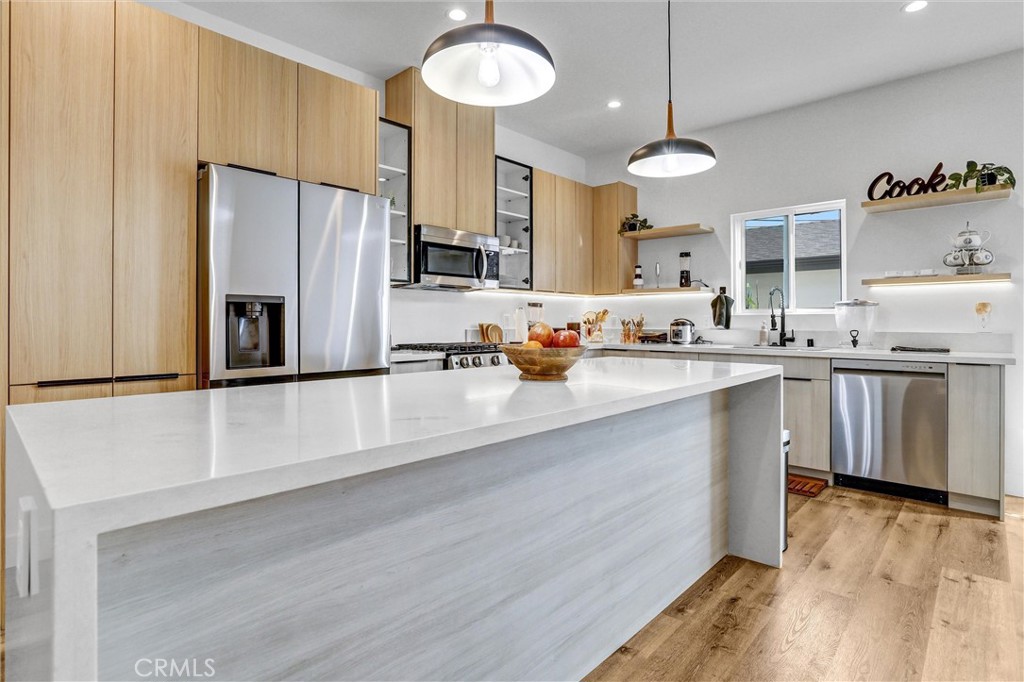 6900 Corbin Avenue Reseda, CA 91335 - Photo 2 of 50 a kitchen with stainless steel appliances a refrigerator a sink a stove and a wooden floors