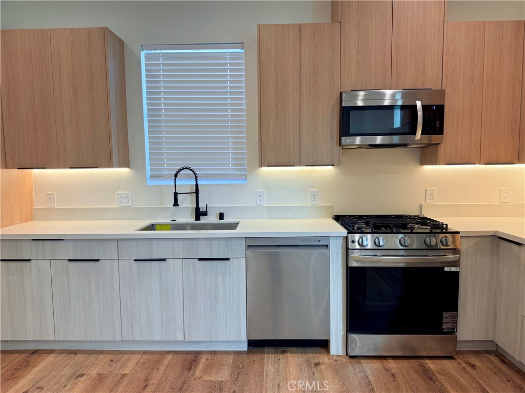 6900 Corbin Avenue Reseda, CA 91335 - Photo 30 of 50 a kitchen with a stove and a microwave