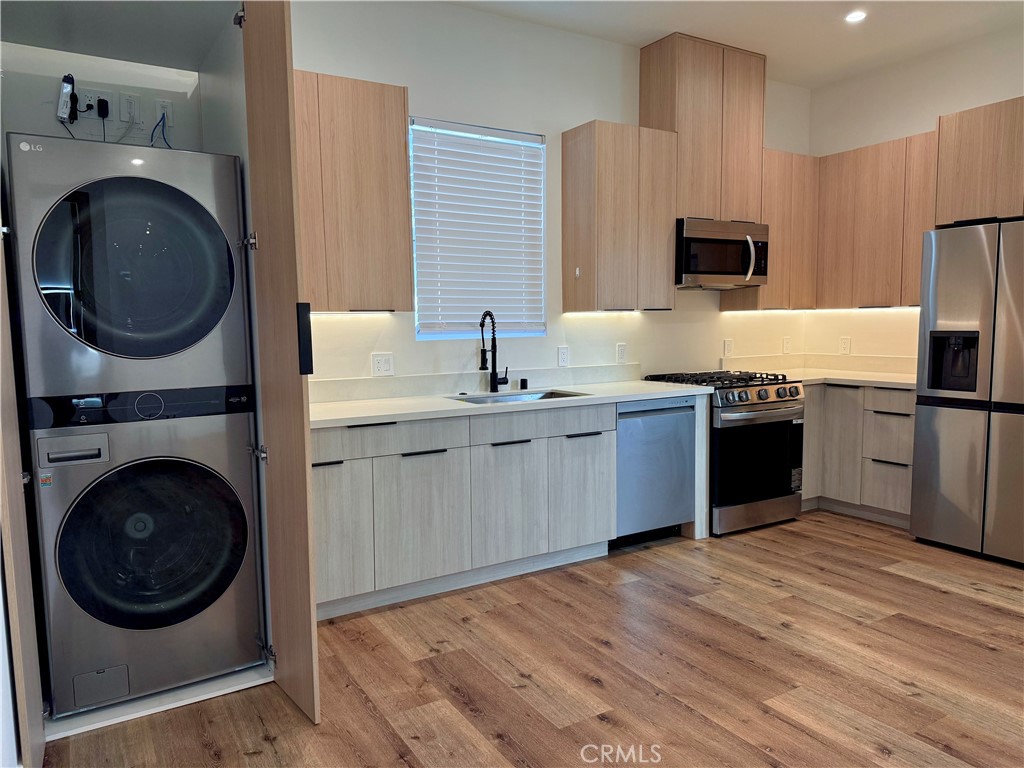 6900 Corbin Avenue Reseda, CA 91335 - Photo 33 of 50 a kitchen with a sink cabinets and stainless steel appliances