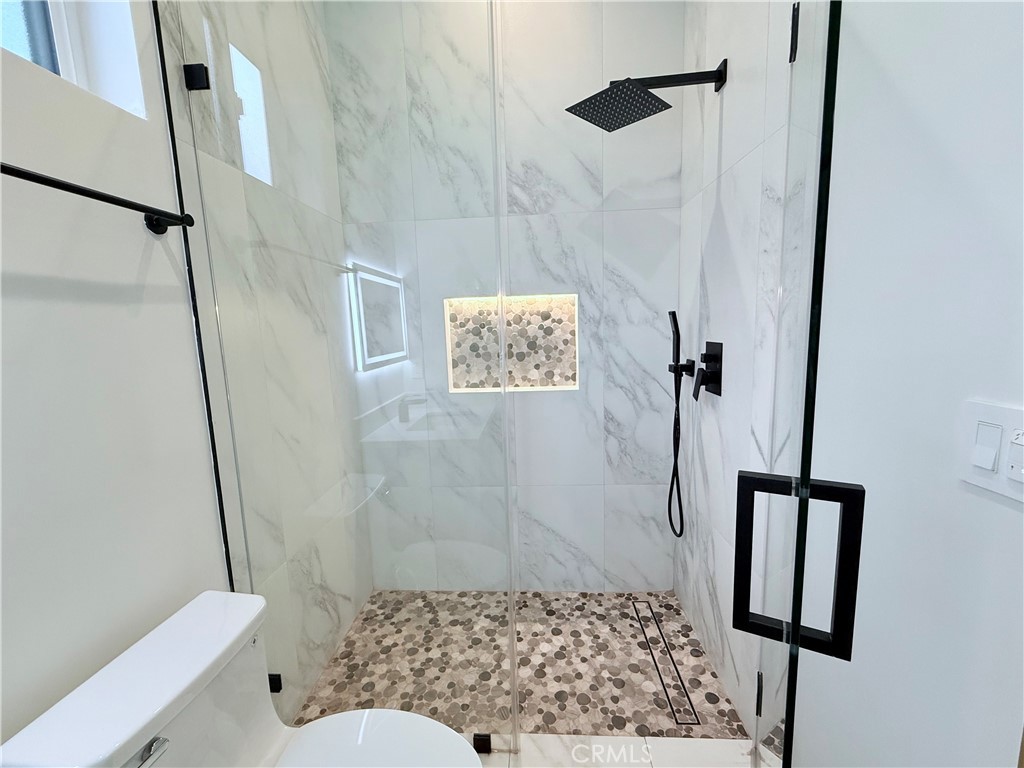 6900 Corbin Avenue Reseda, CA 91335 - Photo 43 of 50 a bathroom with a shower toilet and sink