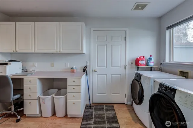 a living room with furniture a air conditioner vent and a window