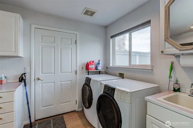 a spacious bathroom with a granite countertop sink and a mirror