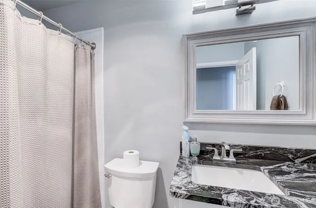 a view of a dining room with furniture and a window