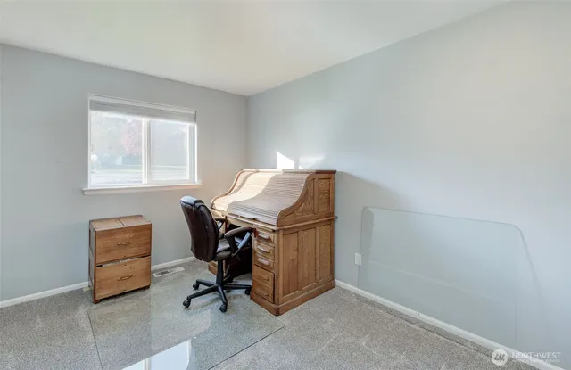 a bedroom with a bed and a painting on the wall