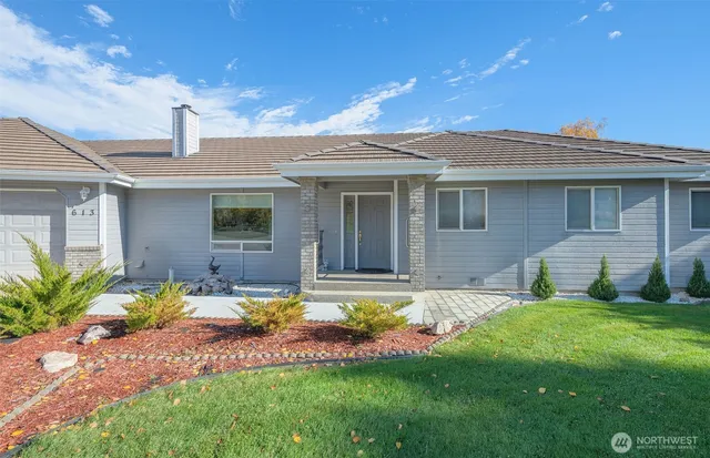 a living room with furniture and a gym machine next to a window