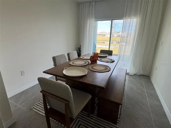 a view of a dining room with furniture and window