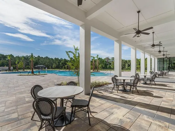a view of a patio with a dining table and chairs