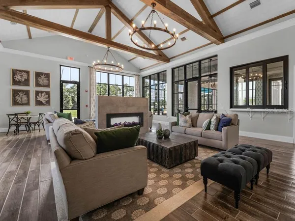 a living room with furniture ceiling fan and a window