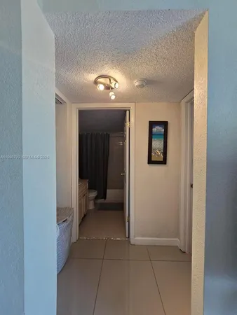 a view of a hallway with wooden shelves