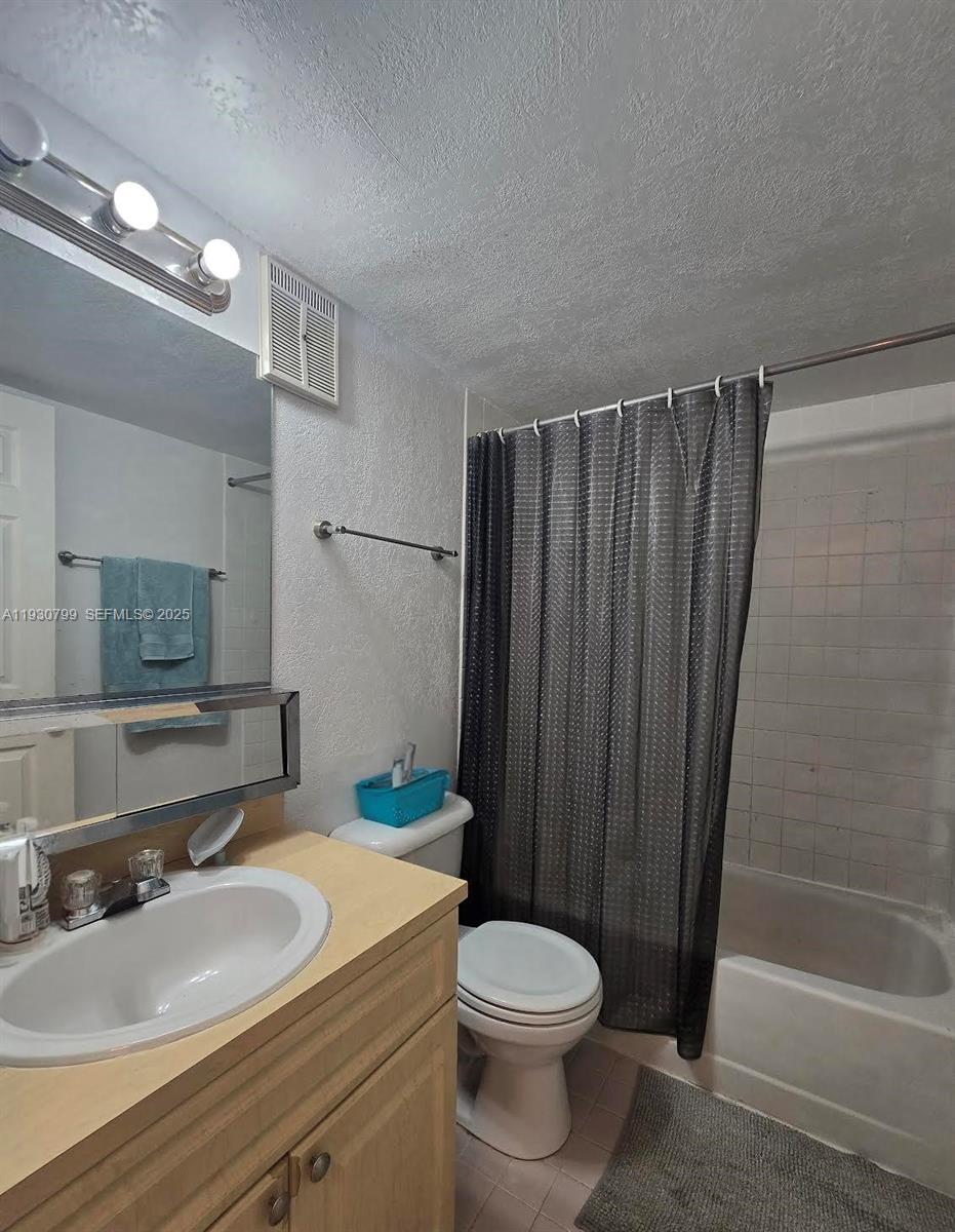 8200 Southwest 210th Street, Unit 103 Cutler Bay, FL 33189 - Photo 6 of 19 a bathroom with a sink a toilet and shower