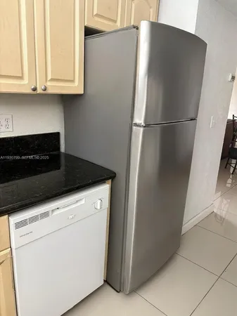 a kitchen with granite countertop cabinets stainless steel appliances and a counter space