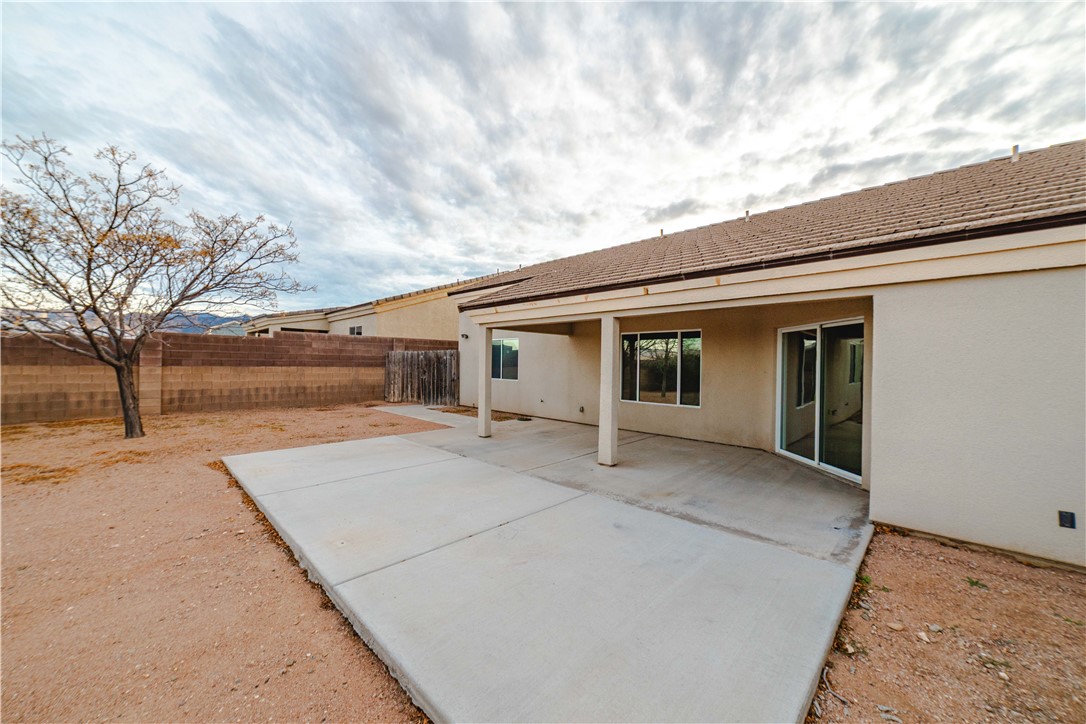3374 Roma Road Kingman, AZ 86401 - Photo 55 of 64 Rear view of property with a fenced backyard, stucco siding, and a patio