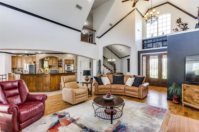 a living room with furniture a fireplace and a floor to ceiling window