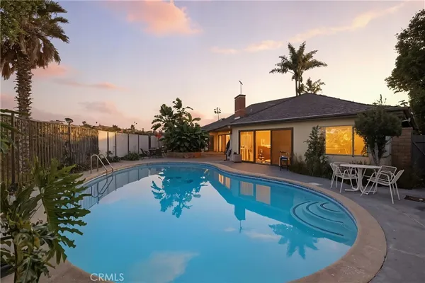 a swimming pool with outdoor seating yard and barbeque oven