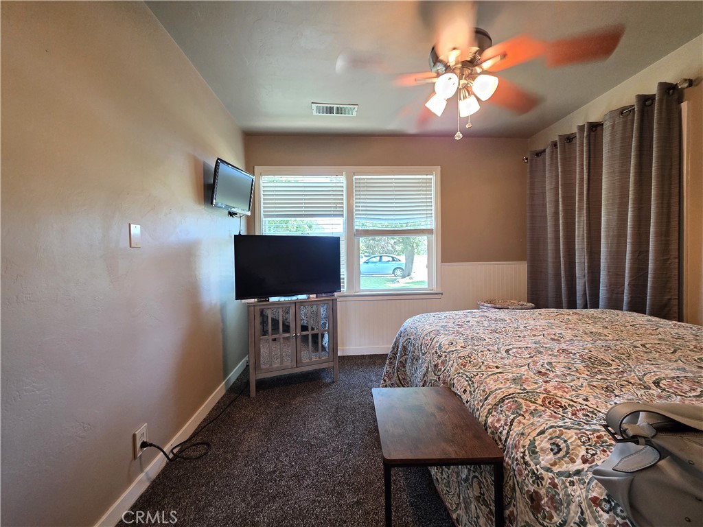 23773 River Road Corning, CA 96021 - Photo 19 of 64 a bedroom with a bed and a flat screen tv