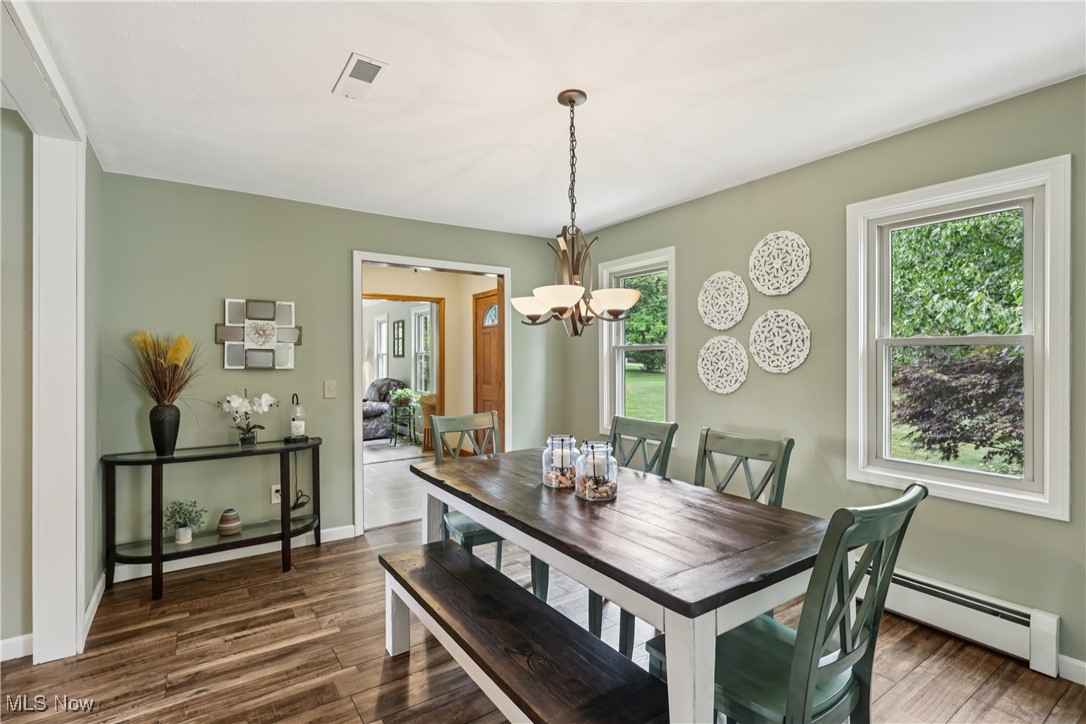 4101 Huffman Road Medina, OH 44256 - Photo 8 of 48 Dining space with a baseboard heating unit, dark wood-type flooring, and a chandelier
