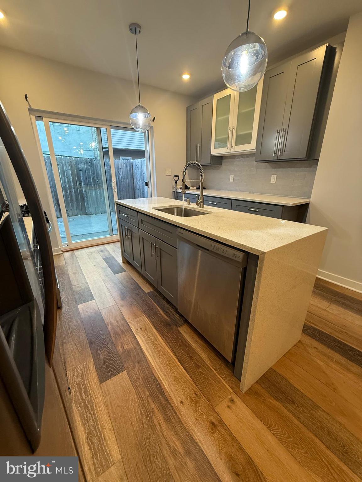 2309 Cross Street Philadelphia, PA 19146 - Photo 11 of 37 a large kitchen with stainless steel appliances a large counter top a sink a stove and a refrigerator