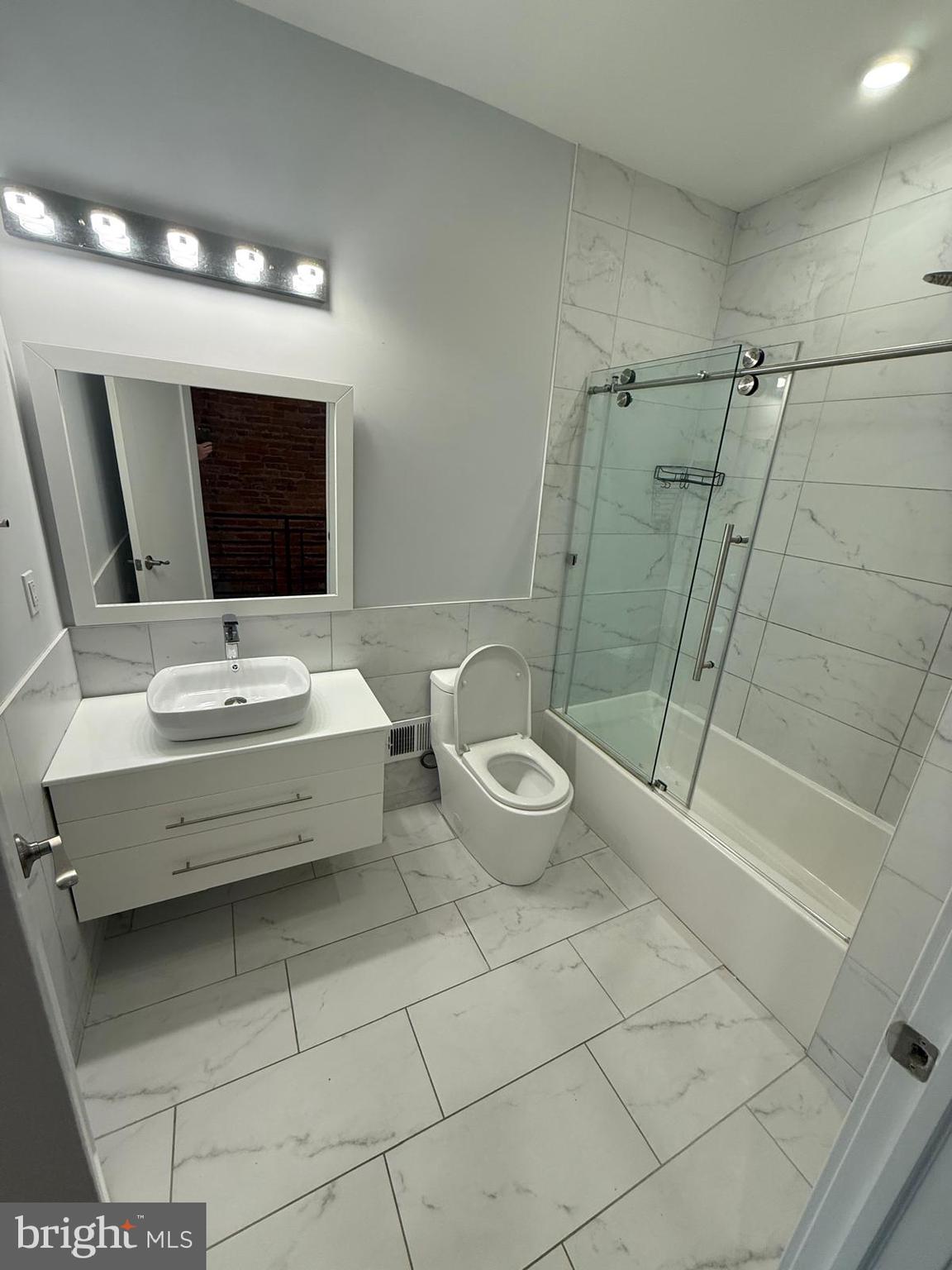 2309 Cross Street Philadelphia, PA 19146 - Photo 28 of 37 a bathroom with a toilet a sink and mirror