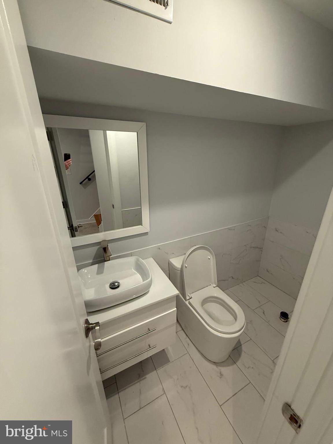 2309 Cross Street Philadelphia, PA 19146 - Photo 33 of 37 a bathroom with a toilet a sink and mirror