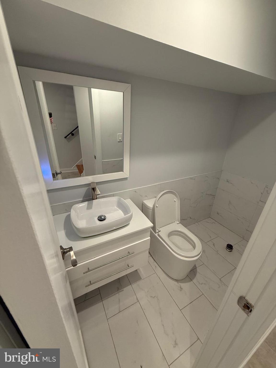 2309 Cross Street Philadelphia, PA 19146 - Photo 34 of 37 a bathroom with a toilet a sink and mirror