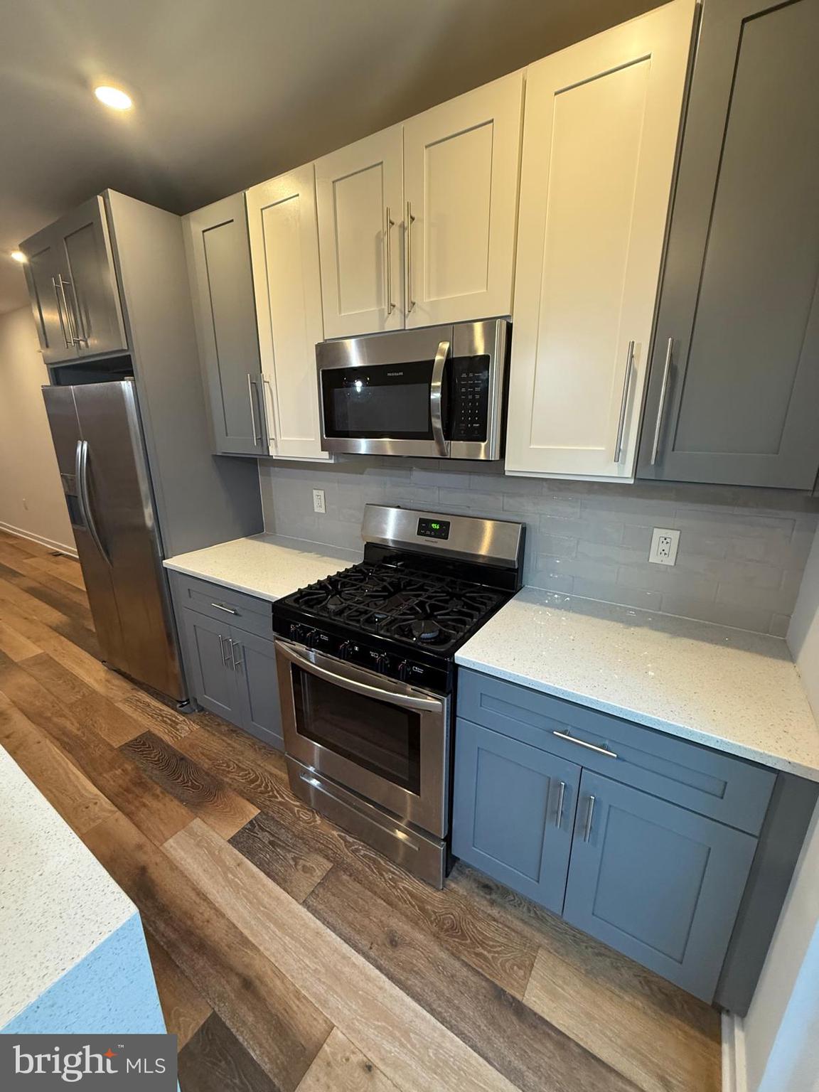 2309 Cross Street Philadelphia, PA 19146 - Photo 7 of 37 a kitchen with wooden cabinets and a stove top oven