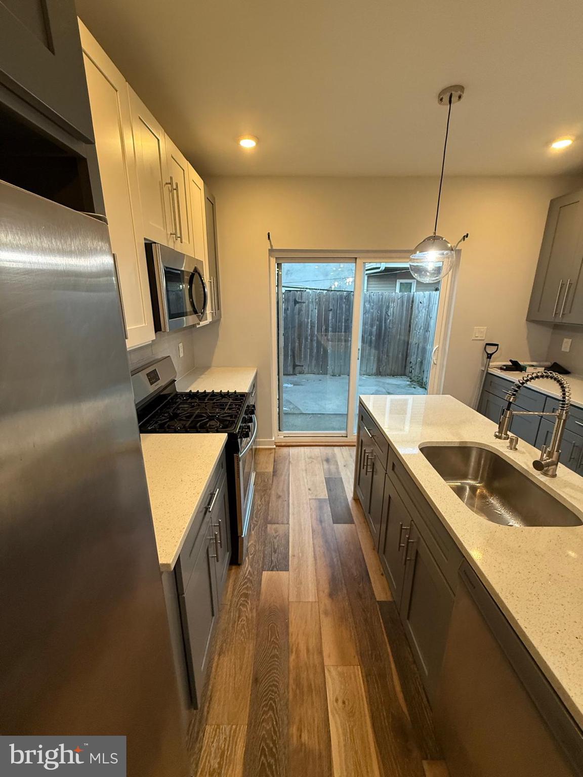 2309 Cross Street Philadelphia, PA 19146 - Photo 8 of 37 a kitchen with sink a microwave a stove and refrigerator