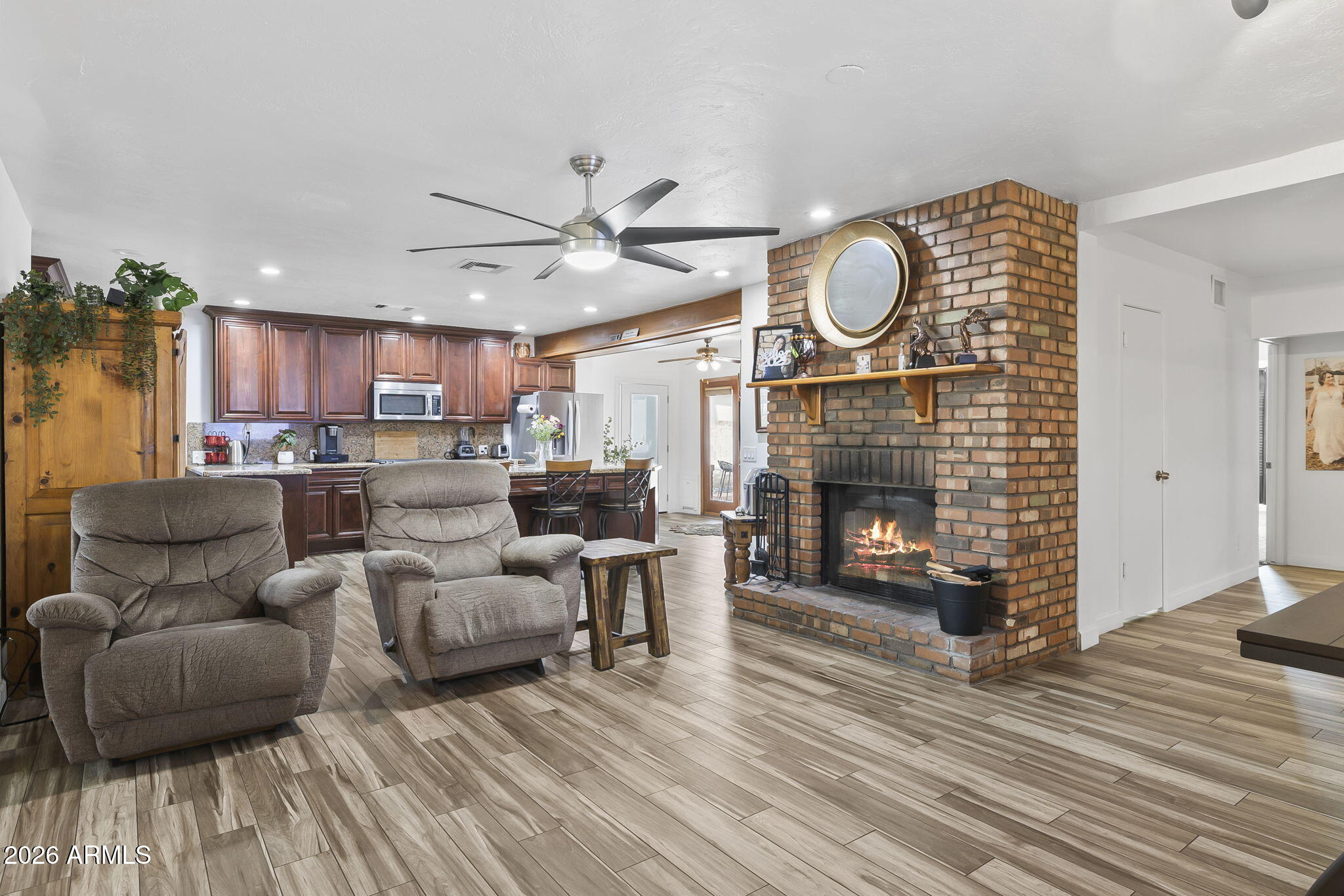 1607 West Whitton Avenue Phoenix, AZ 85015 - Photo 9 of 45 a living room with furniture a fireplace a rug and a fireplace