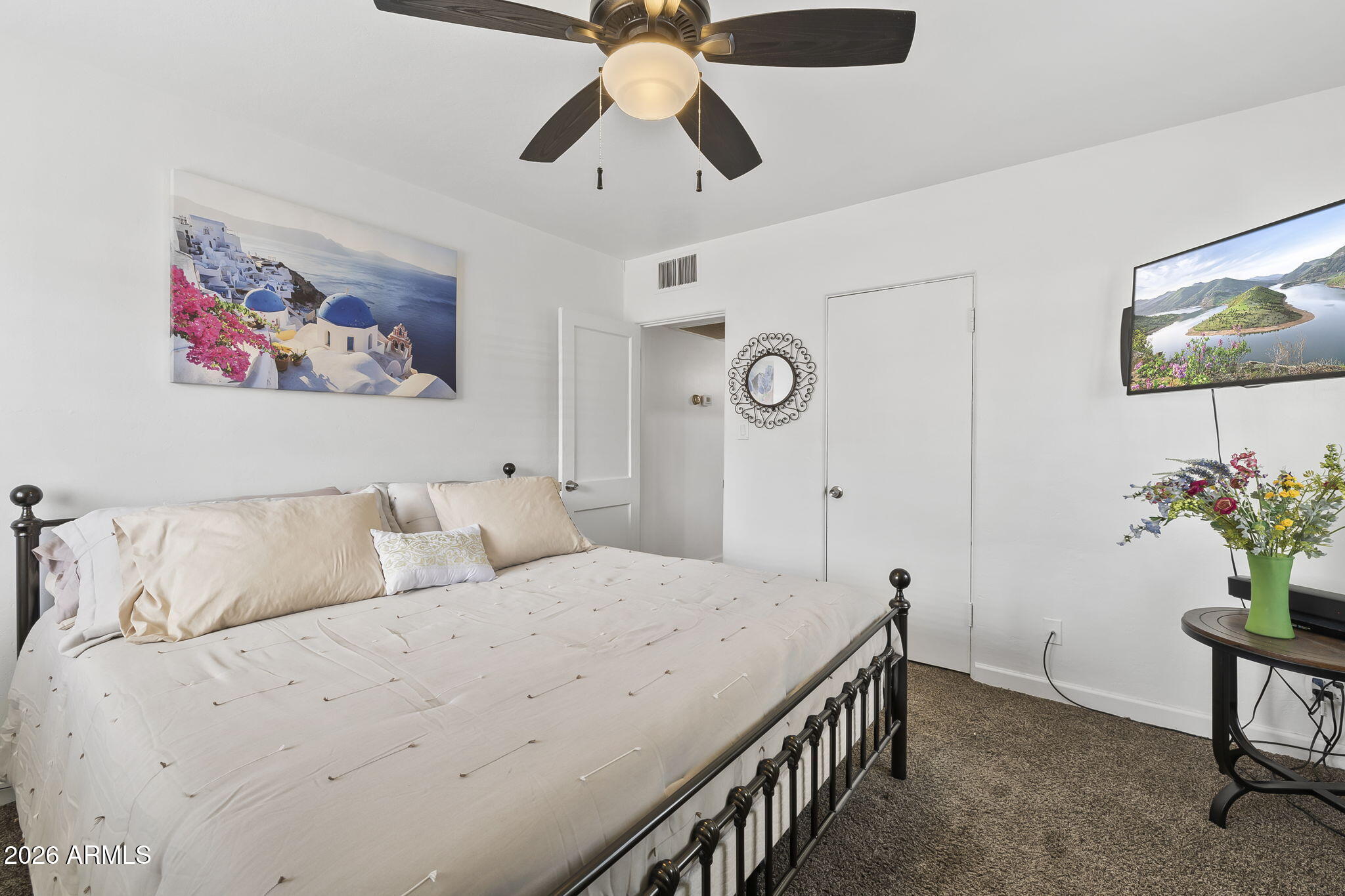 1607 West Whitton Avenue Phoenix, AZ 85015 - Photo 17 of 45 a bedroom with a bed and a chandelier