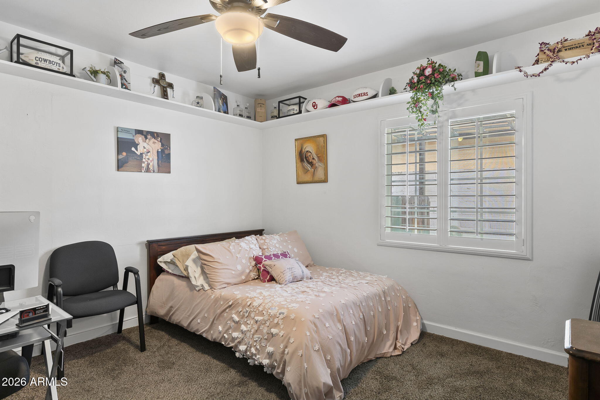 1607 West Whitton Avenue Phoenix, AZ 85015 - Photo 19 of 45 a bed sitting in a bedroom next to a window and a chair