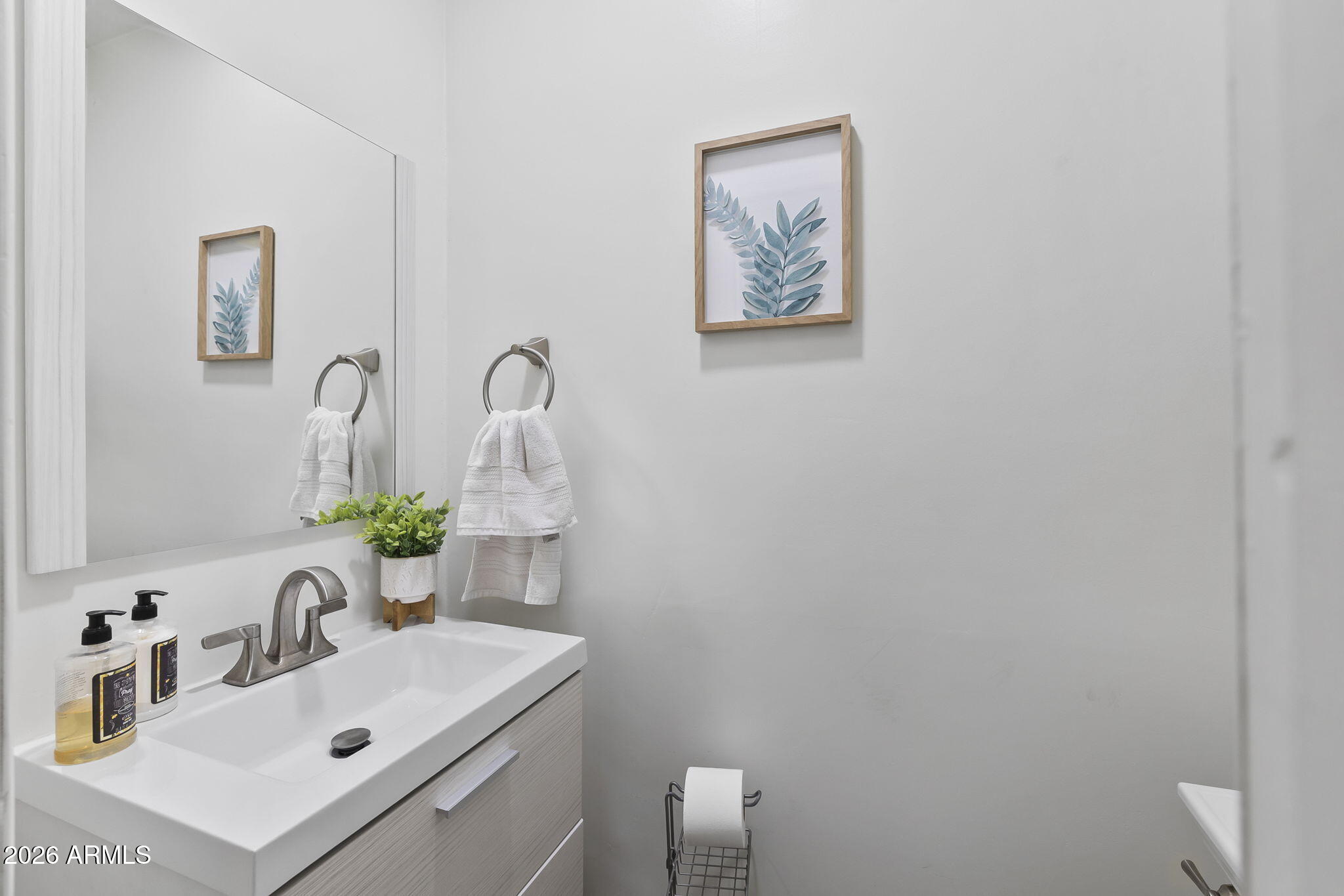 1607 West Whitton Avenue Phoenix, AZ 85015 - Photo 33 of 45 a bathroom with a sink vanity and mirror