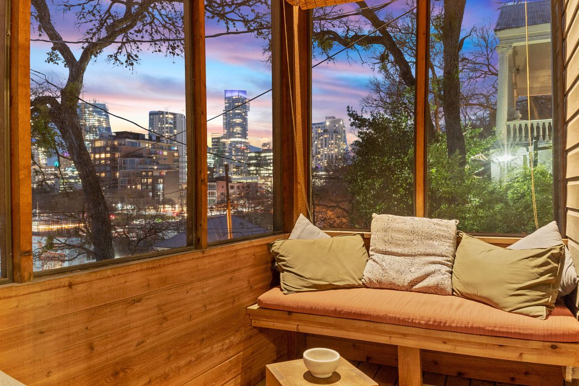 a view of a patio with couches chairs and wooden floor