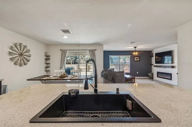 a kitchen with stainless steel appliances a stove a sink dishwasher and cabinets