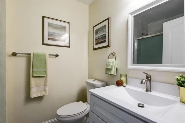 a bathroom with a sink toilet and mirror