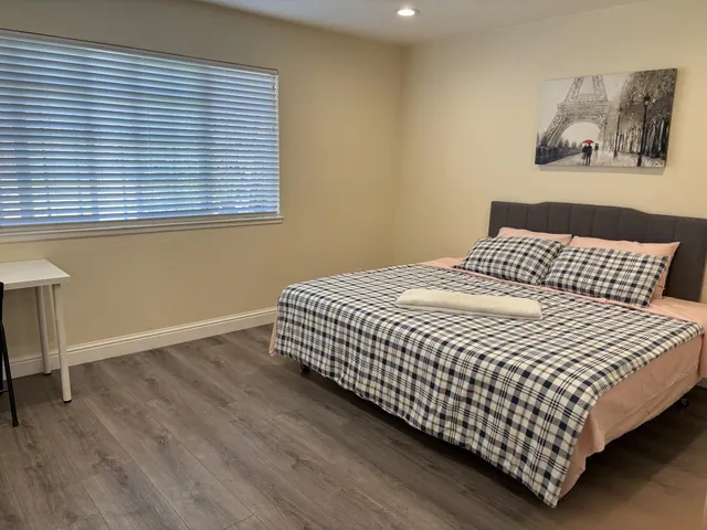 a bedroom with a bed and a window
