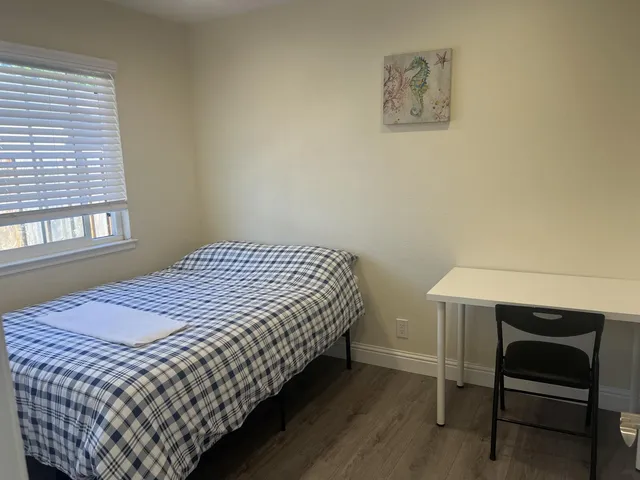 a bedroom with a bed and a chair