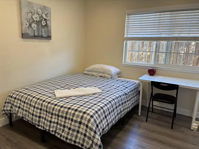 a bedroom with a bed and a window