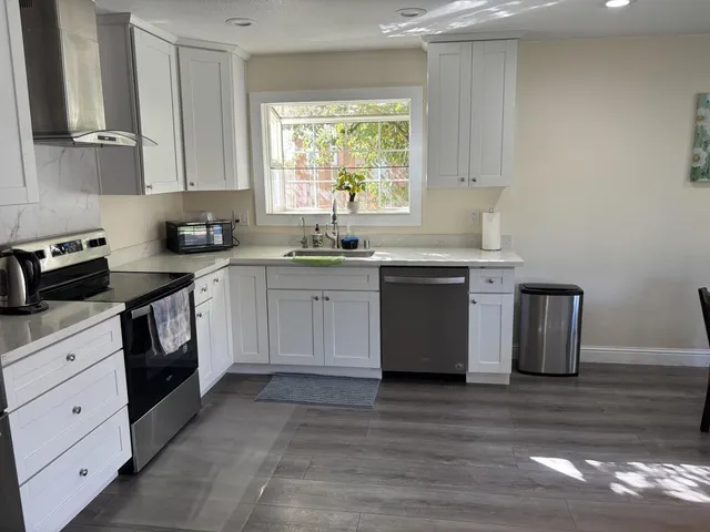a kitchen with a sink stove and cabinets