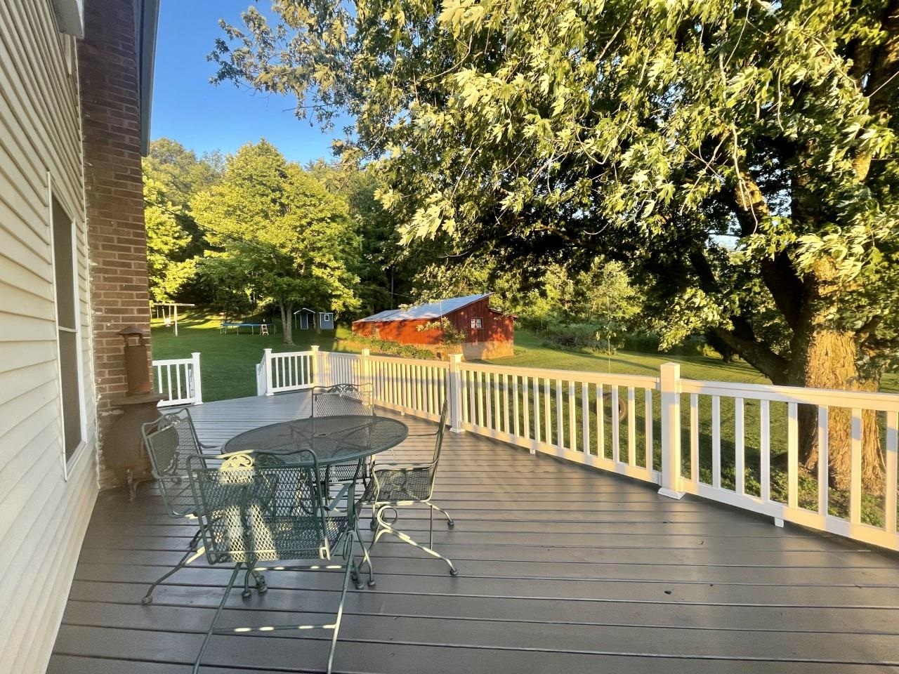 3669 Scenic Bluff Road Thomson, IL 61285 - Photo 28 of 38 a view of a patio with table and chairs with wooden floor and fence