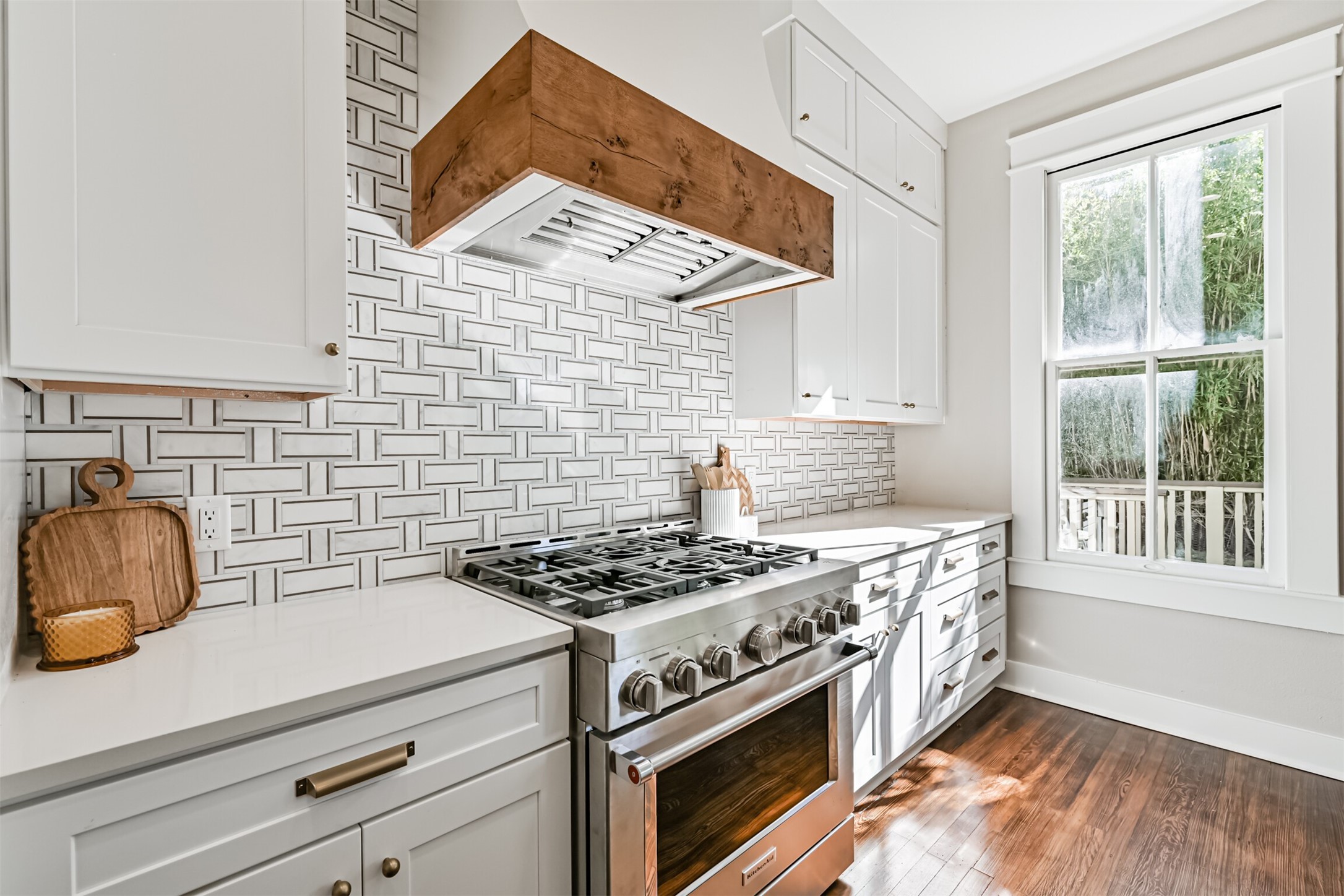 1310 Rosenberg Street Galveston, TX 77550 - Photo 11 of 50 a kitchen with stainless steel appliances a stove a sink and white cabinets