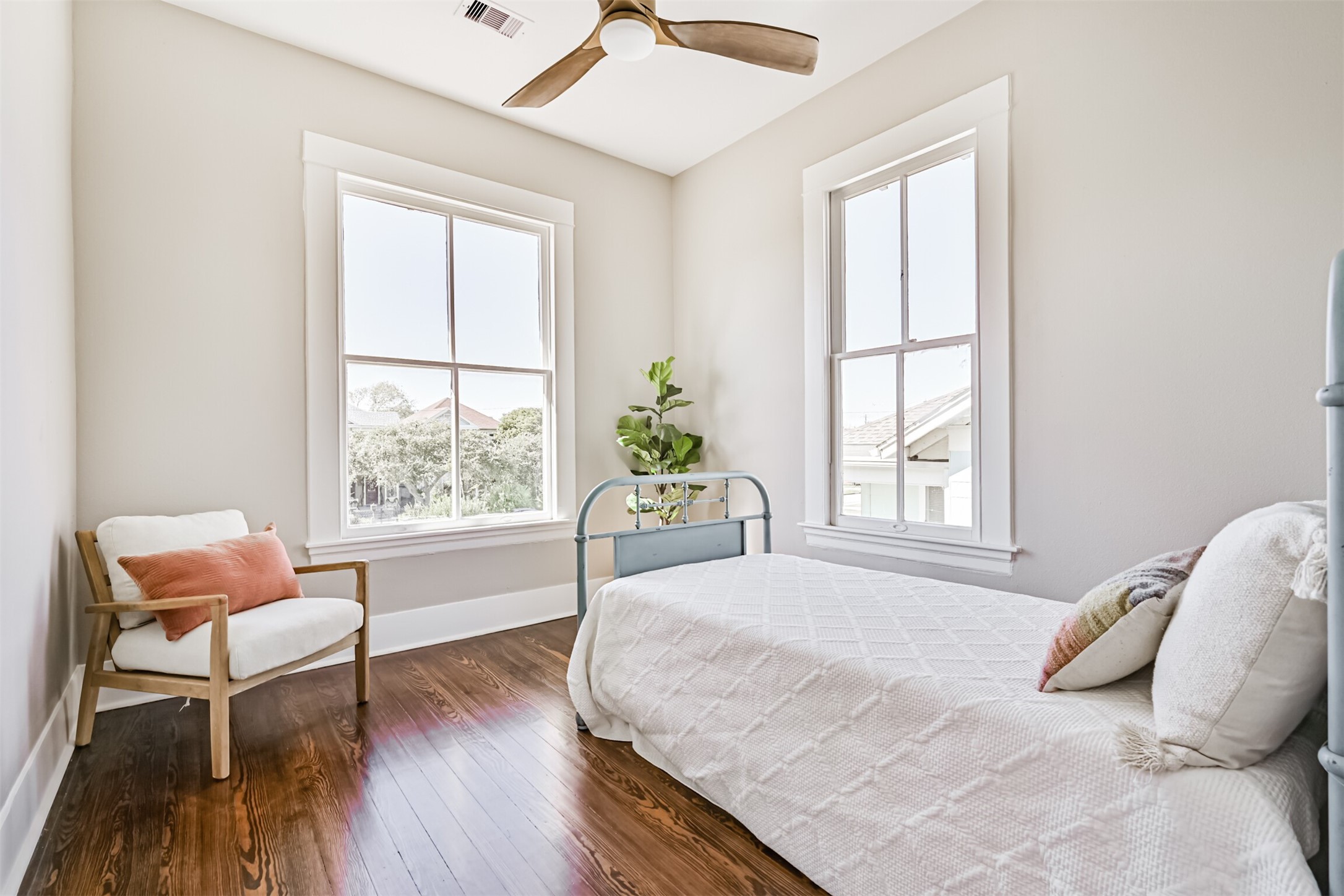 1310 Rosenberg Street Galveston, TX 77550 - Photo 26 of 50 a bedroom with a bed and wooden floor