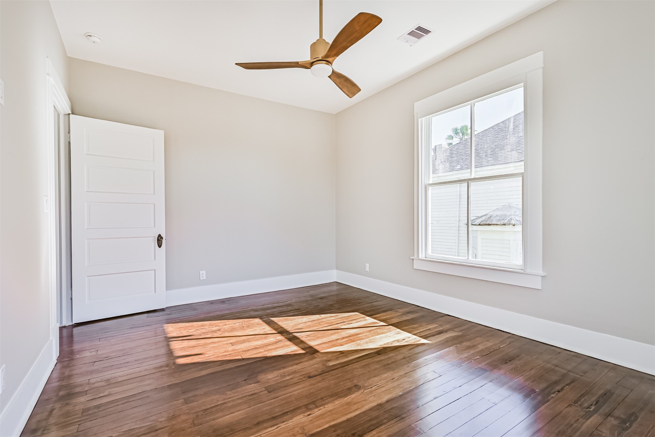1310 Rosenberg Street Galveston, TX 77550 - Photo 32 of 50 an empty room with wooden floor and windows