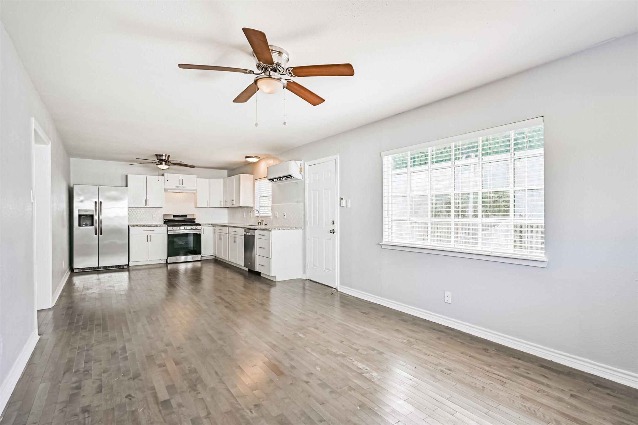 1310 Rosenberg Street Galveston, TX 77550 - Photo 36 of 50 a view of a kitchen with furniture a ceiling fan and wooden floor