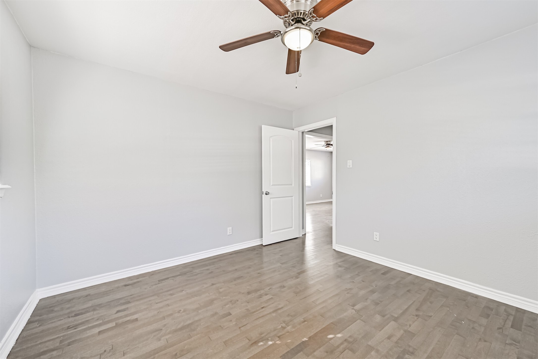 1310 Rosenberg Street Galveston, TX 77550 - Photo 37 of 50 an empty room with wooden floor closet and fan