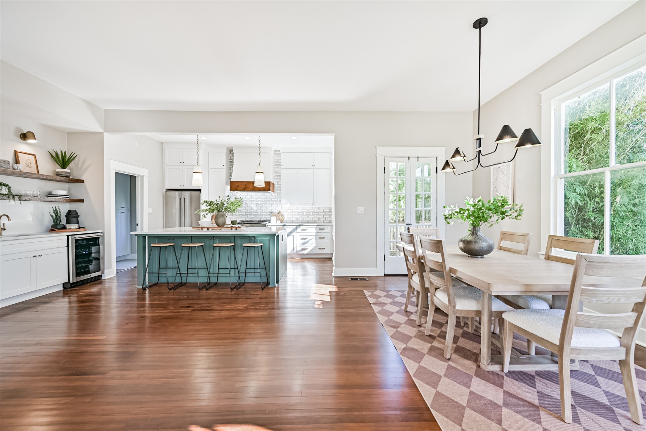 1310 Rosenberg Street Galveston, TX 77550 - Photo 7 of 50 a dining room with furniture wooden floor a chandelier and a rug