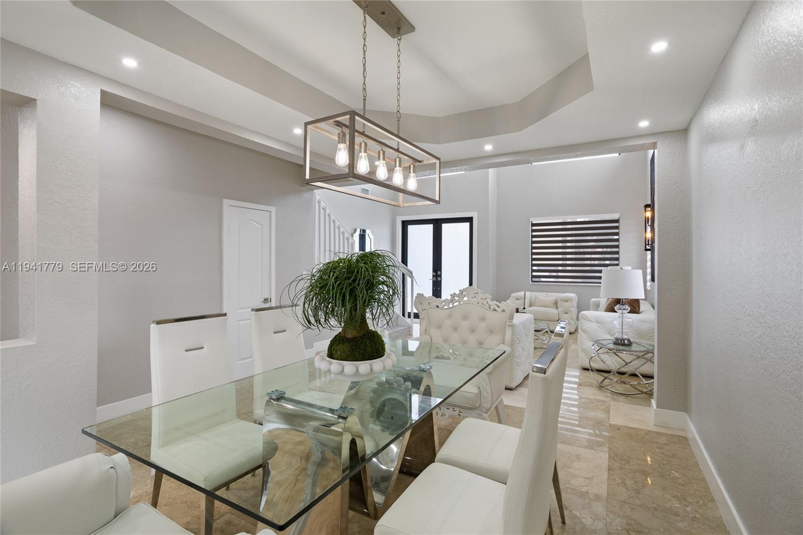 5324 Southwest 164th Court Miami, FL 33185 - Photo 20 of 47 a view of a dining room with furniture and a chandelier